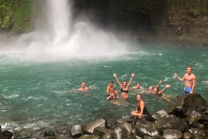 People swimming at La Fortuna Waterfall in Arenal