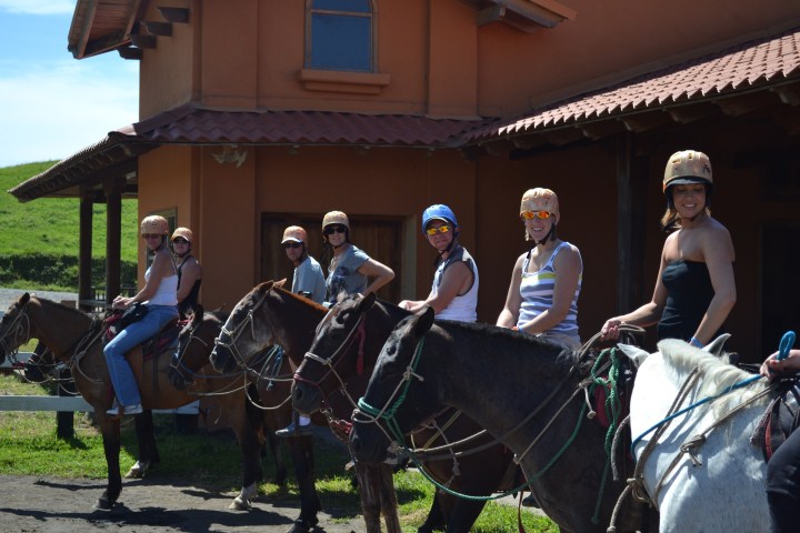 People getting ready for riding horses